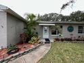 House entrance with walkway and well-maintained landscaping at 806 E 2Nd Ave, New Smyrna Beach, FL 32169