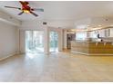 Spacious living room with tile flooring, sliding doors to balcony, and kitchen at 5300 S Atlantic Ave # 9201, New Smyrna Beach, FL 32169