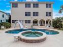Large kidney-shaped pool with spa and slide at 610 S Atlantic Ave, New Smyrna Beach, FL 32169