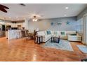 Open living and kitchen area with hardwood floors and white sectional sofa at 610 S Atlantic Ave, New Smyrna Beach, FL 32169