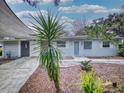 Updated home with modern gray exterior and landscaping at 104 Fran Dr, New Smyrna Beach, FL 32168