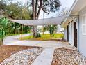 Home with covered patio and landscaped front yard at 104 Fran Dr, New Smyrna Beach, FL 32168