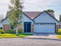 House exterior with brick and vinyl siding, and a two-car garage at 804 Soft Pine Ct, New Smyrna Beach, FL 32168