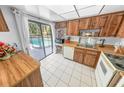 Bright kitchen with wood cabinets and pool access at 1213 Jeffery Dr, Port Orange, FL 32129