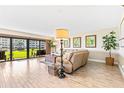 Living room with sliding doors to a grassy patio area at 4501 S Atlantic Ave # 1210, New Smyrna Beach, FL 32169
