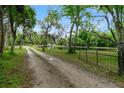 Long driveway leading to house near a pond at 1795 Hideaway Ln, Edgewater, FL 32141
