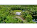 House nestled in a private wooded area near a pond at 1795 Hideaway Ln, Edgewater, FL 32141