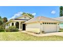 One-story home with a two-car garage and well-maintained lawn at 806 Pine Shores Cir, New Smyrna Beach, FL 32168