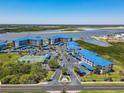 Aerial view of waterfront condo community with tennis courts and parking at 2700 N Peninsula Ave # 536, New Smyrna Beach, FL 32169