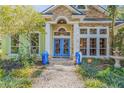 Inviting entrance with blue double doors and stonework at 2300 Captain Butler Trl, New Smyrna Beach, FL 32168