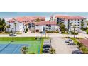 Aerial view showing condo complex and tennis court at 3001 S Atlantic Ave # 502, New Smyrna Beach, FL 32169