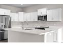Modern kitchen with white cabinets and quartz countertops at 402 Oliver Dr, New Smyrna Beach, FL 32168