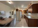 Kitchen with wood cabinets, white appliances, and a small dining area at 535 S Peninsula Ave, New Smyrna Beach, FL 32169