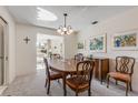 Dining room with a wood table and chairs, adjacent to the living room at 535 S Peninsula Ave, New Smyrna Beach, FL 32169