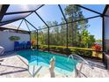 Inviting screened-in pool with a mermaid statue and seating at 933 Attitude Ave, Daytona Beach, FL 32124
