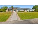 House exterior, light blue with stone accents, and a walkway at 756 Bay Dr, New Smyrna Beach, FL 32168