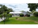 Charming single story home with gray siding, metal roof and a paved driveway at 1238 Wayne Ave, New Smyrna Beach, FL 32168