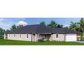 Tan one-story house with a dark roof and two car garage at 128 Indian Creek Rd, Oak Hill, FL 32759