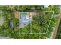 Aerial view showing house, pool, and large lot at 1328 Needle Palm Dr, Edgewater, FL 32132