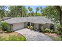 House with a pool, located on a tree-lined street at 1328 Needle Palm Dr, Edgewater, FL 32132