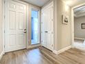 Bright entryway with tile floors, coat closet and access to balcony at 1 Riverwalk Dr # 206, New Smyrna Beach, FL 32169