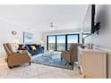 Living room with ocean view, featuring ample seating and a large TV at 5301 S Atlantic Ave # 630, New Smyrna Beach, FL 32169
