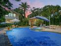 Inviting pool area with spa, patio furniture, and a fire pit at 1006 S Riverside Dr, Edgewater, FL 32132