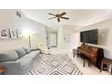 Bright and airy living room featuring comfortable seating and large TV at 790 Pine Shores Cir, New Smyrna Beach, FL 32168