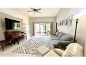 Spacious living room with tiled floors and access to a patio at 790 Pine Shores Cir, New Smyrna Beach, FL 32168
