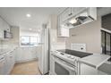 Modern kitchen with white cabinets, quartz countertops, and stainless steel appliances at 2401 S Atlantic Ave # D304, New Smyrna Beach, FL 32169