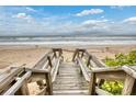 Wooden staircase leading to the beach at 6368 S Atlantic Ave, New Smyrna Beach, FL 32169