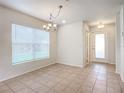 Spacious dining area with large window and tile flooring at 521 Mount Olympus Blvd, New Smyrna Beach, FL 32168