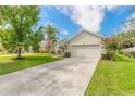 Single story house with attached garage and a lush green lawn at 117 Opal Hill Cir, Daytona Beach, FL 32124