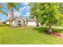 House exterior showcasing a manicured lawn and landscaping at 117 Opal Hill Cir, Daytona Beach, FL 32124