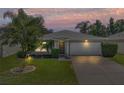 Attractive one-story house, nicely landscaped, at dusk at 5321 Cordgrass Bend Ln, Port Orange, FL 32128
