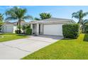 One story home with a white garage door and well-manicured lawn at 5321 Cordgrass Bend Ln, Port Orange, FL 32128