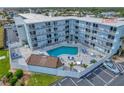 Aerial view of condo building with pool and ocean view at 3700 S Atlantic Ave # 402, New Smyrna Beach, FL 32169