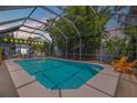 Enclosed pool area with lounge chairs at 119 Hardin Pl, Edgewater, FL 32132