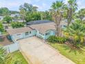 Aerial view of teal house and driveway at 119 Hardin Pl, Edgewater, FL 32132