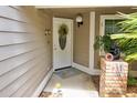Inviting front entrance with a white door, wreath, and landscaping at 2051 Cornell Pl, Port Orange, FL 32128