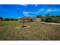View of the house from the side yard, showing a spacious lawn and landscaping at 15190 Cr-565A, Clermont, FL 34711