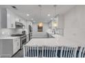 Modern kitchen with white cabinets, quartz countertops, and island at 40 Oak Tree Dr, New Smyrna Beach, FL 32169