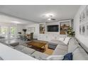 Spacious living room with L-shaped sofa and built-in shelving at 40 Oak Tree Dr, New Smyrna Beach, FL 32169