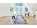Open living area with high ceilings, stylish rug, and access to patio at 624 Volco Rd, Edgewater, FL 32141