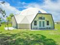 Eye-catching white geodesic dome home with green lawn at 624 Volco Rd, Edgewater, FL 32141