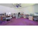 Home office featuring two desks, ample workspace, and purple carpeting at 1319 Orange Tree Dr, Edgewater, FL 32132