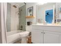 Updated bathroom with a white vanity, mosaic tile shower, and a bathtub at 3750 S Atlantic Ave # 180, Daytona Beach Shores, FL 32118