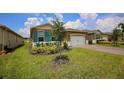 House with teal shutters and a paved driveway at 1726 Red Rock Rd, New Smyrna Beach, FL 32168