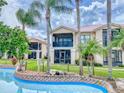 Community lazy river winding through lush landscaping at 406 Bouchelle Dr # 206, New Smyrna Beach, FL 32169