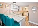 Modern kitchen with white cabinets, stainless steel appliances, and a breakfast bar at 4175 S Atlantic Ave # 4120, New Smyrna Beach, FL 32169